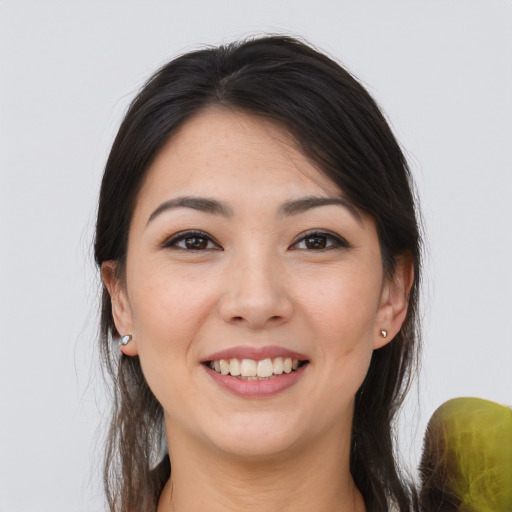 Joyful white young-adult female with long  brown hair and brown eyes