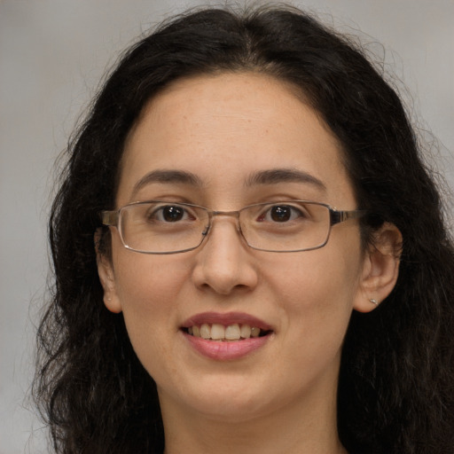 Joyful white adult female with long  brown hair and brown eyes