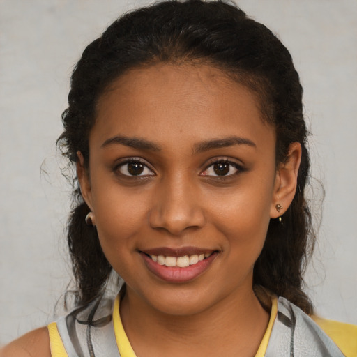 Joyful black young-adult female with short  brown hair and brown eyes