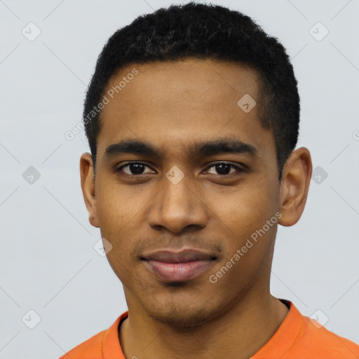 Joyful black young-adult male with short  black hair and brown eyes