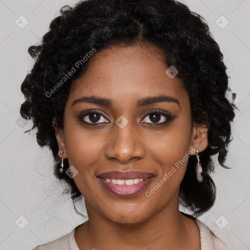 Joyful black young-adult female with long  black hair and brown eyes