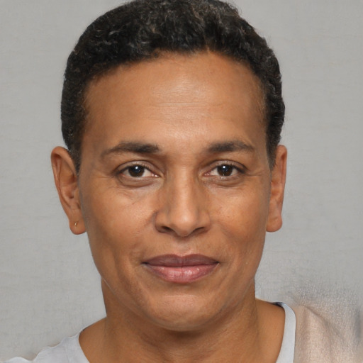 Joyful black adult male with short  black hair and brown eyes