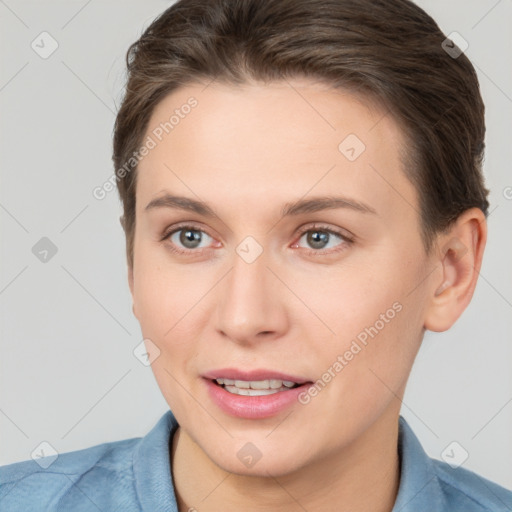 Joyful white young-adult female with short  brown hair and grey eyes