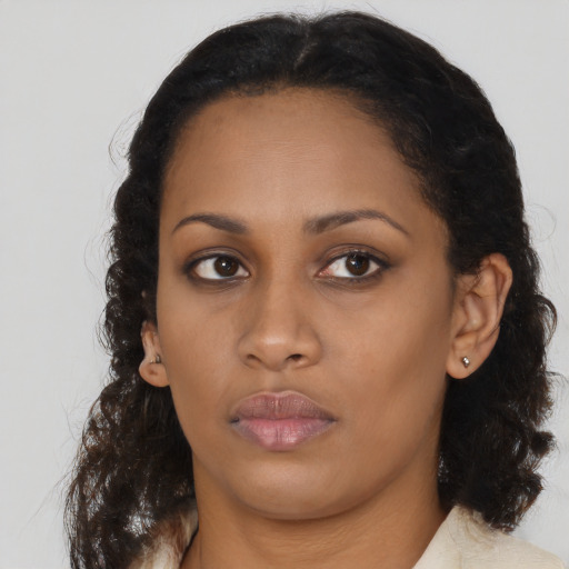 Neutral black young-adult female with medium  brown hair and brown eyes
