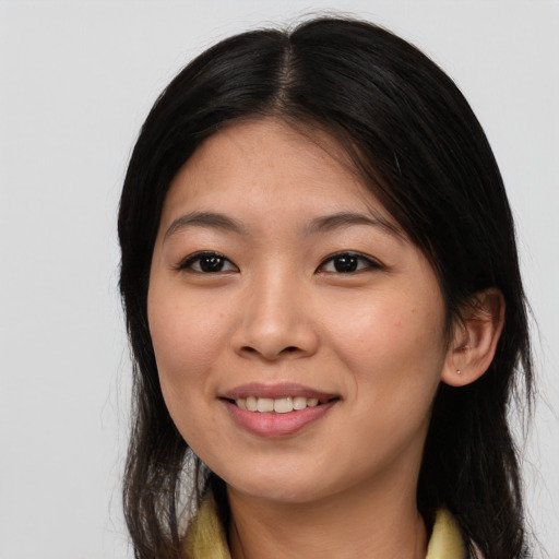 Joyful asian young-adult female with long  brown hair and brown eyes