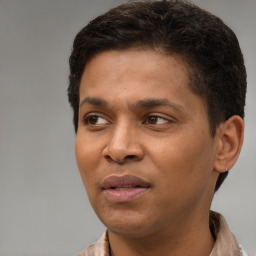 Joyful black young-adult male with short  brown hair and brown eyes