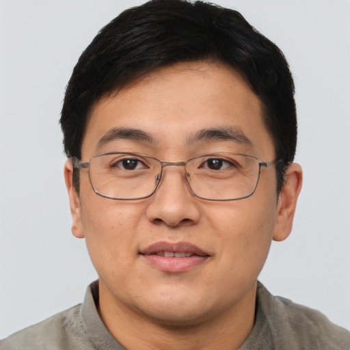 Joyful asian adult male with short  brown hair and brown eyes