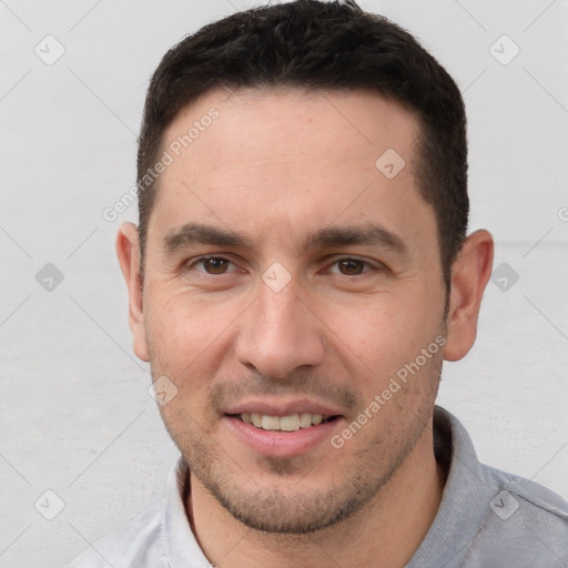 Joyful white young-adult male with short  brown hair and brown eyes