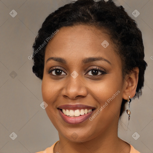 Joyful black young-adult female with short  brown hair and brown eyes