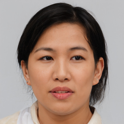 Joyful asian young-adult female with medium  black hair and brown eyes