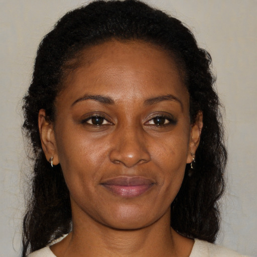 Joyful black young-adult female with medium  brown hair and brown eyes