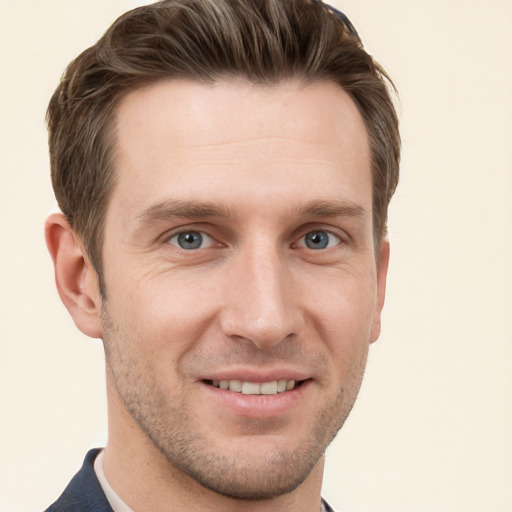 Joyful white young-adult male with short  brown hair and grey eyes