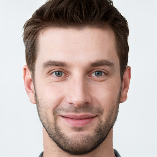 Joyful white young-adult male with short  brown hair and grey eyes