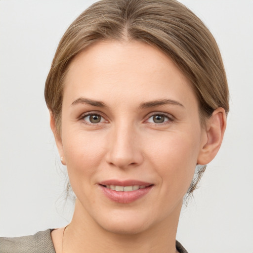 Joyful white young-adult female with medium  brown hair and grey eyes