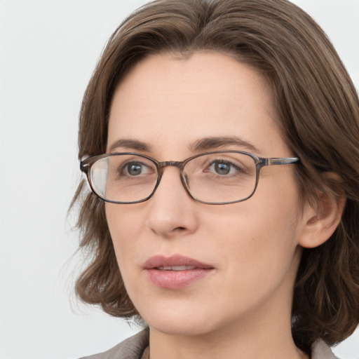 Joyful white young-adult female with medium  brown hair and green eyes