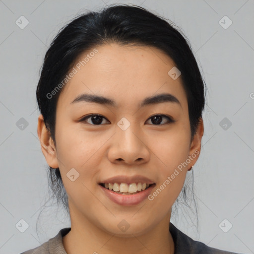 Joyful asian young-adult female with medium  black hair and brown eyes