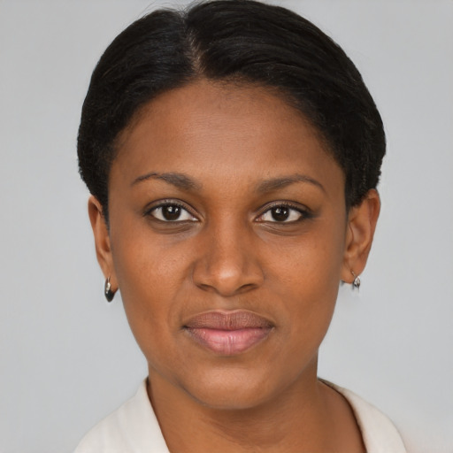 Joyful black young-adult female with short  black hair and brown eyes