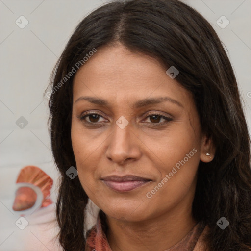 Joyful white adult female with long  brown hair and brown eyes