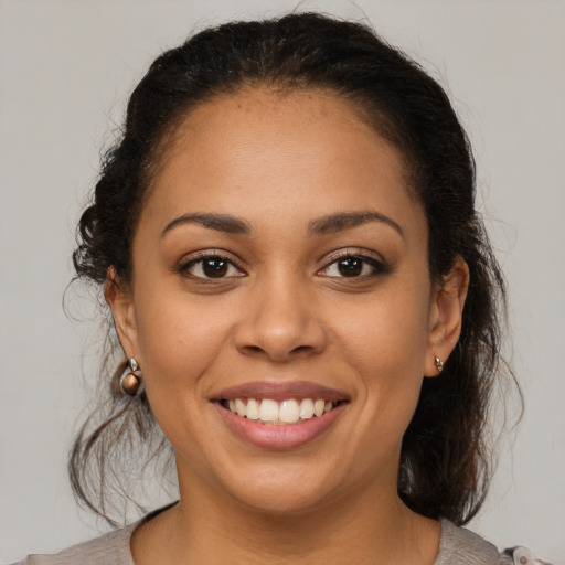 Joyful latino young-adult female with medium  brown hair and brown eyes