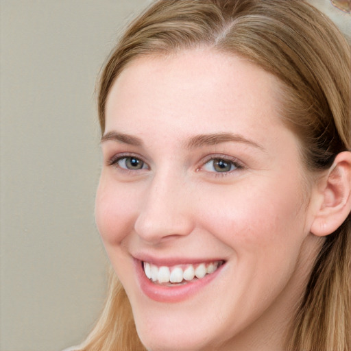 Joyful white young-adult female with long  brown hair and blue eyes