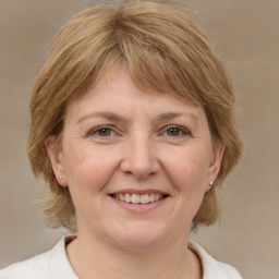 Joyful white adult female with medium  brown hair and grey eyes