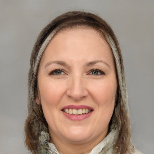 Joyful white adult female with long  brown hair and brown eyes