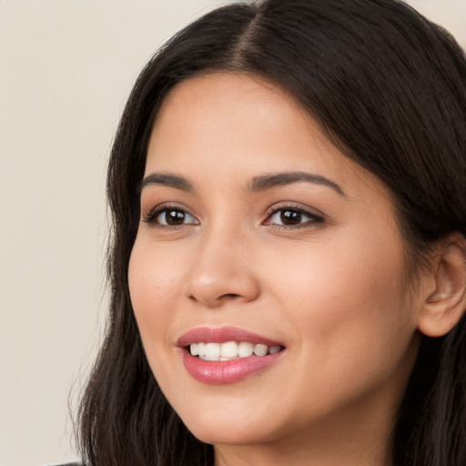 Joyful white young-adult female with long  brown hair and brown eyes