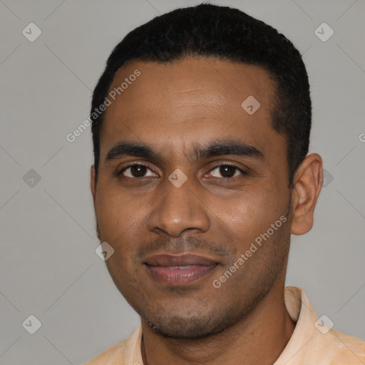 Joyful black young-adult male with short  black hair and brown eyes