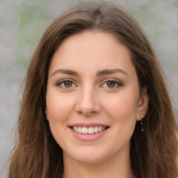 Joyful white young-adult female with long  brown hair and green eyes