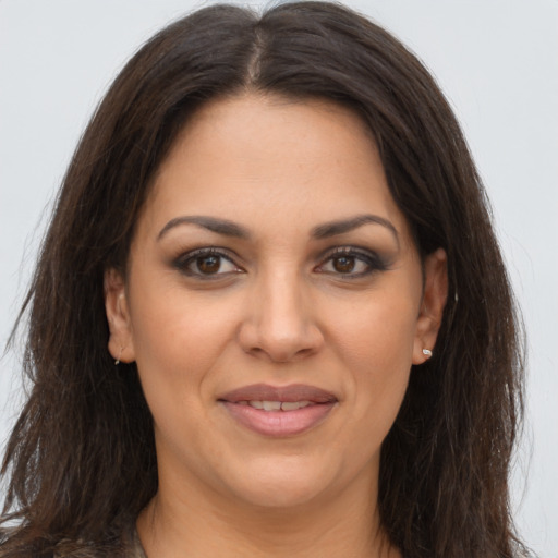 Joyful latino young-adult female with long  brown hair and brown eyes
