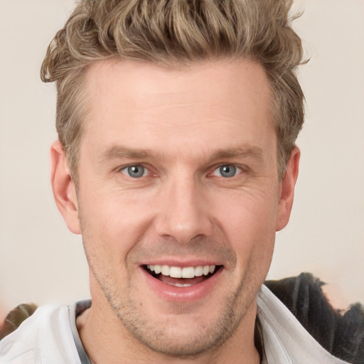 Joyful white adult male with short  brown hair and grey eyes