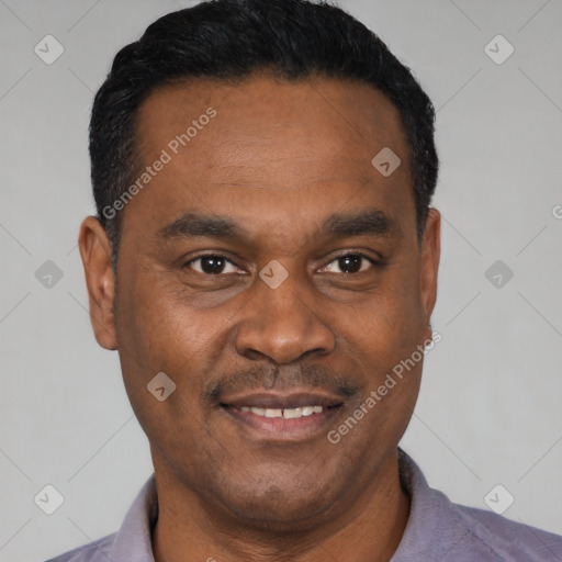 Joyful black young-adult male with short  black hair and brown eyes