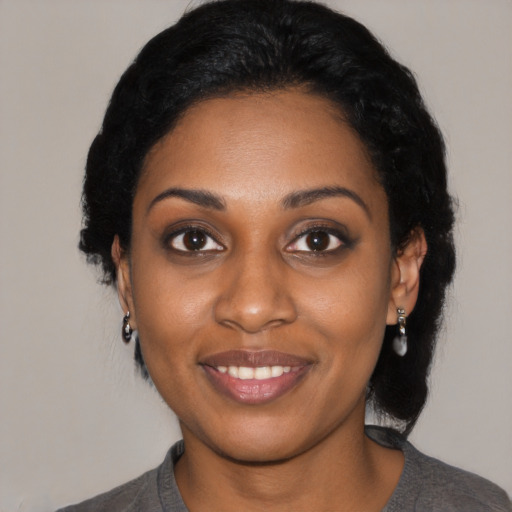 Joyful black young-adult female with medium  black hair and brown eyes