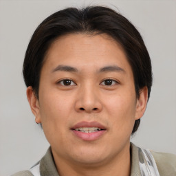 Joyful asian young-adult male with short  brown hair and brown eyes