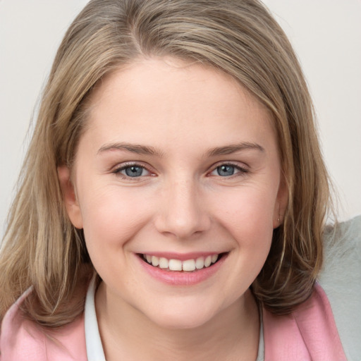 Joyful white child female with medium  brown hair and grey eyes