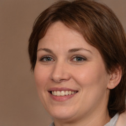 Joyful white adult female with medium  brown hair and brown eyes