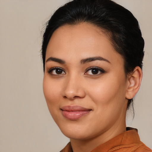 Joyful latino young-adult female with medium  brown hair and brown eyes