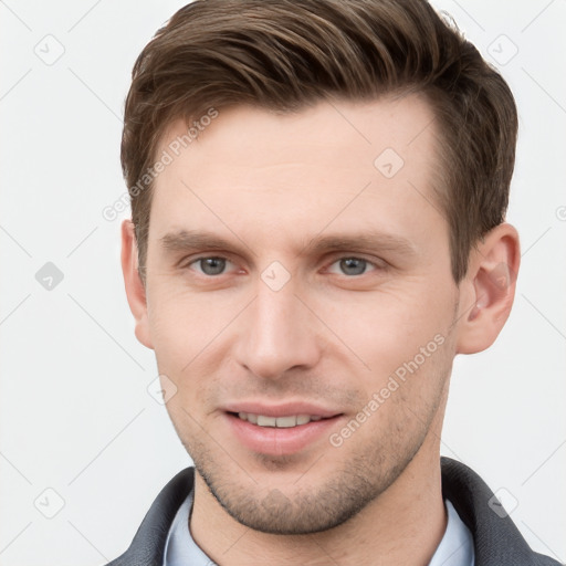 Joyful white young-adult male with short  brown hair and grey eyes