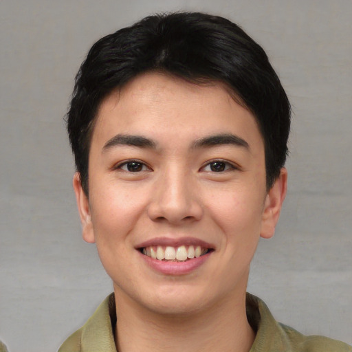 Joyful asian young-adult male with short  brown hair and brown eyes