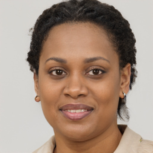 Joyful black adult female with short  brown hair and brown eyes