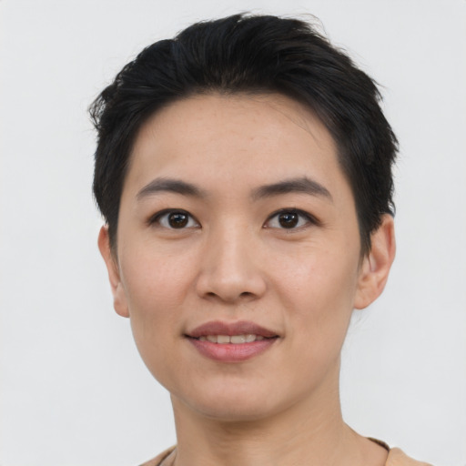 Joyful asian young-adult female with short  black hair and brown eyes