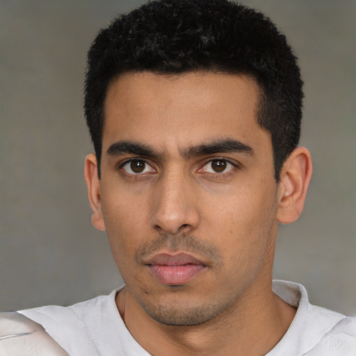Neutral latino young-adult male with short  black hair and brown eyes
