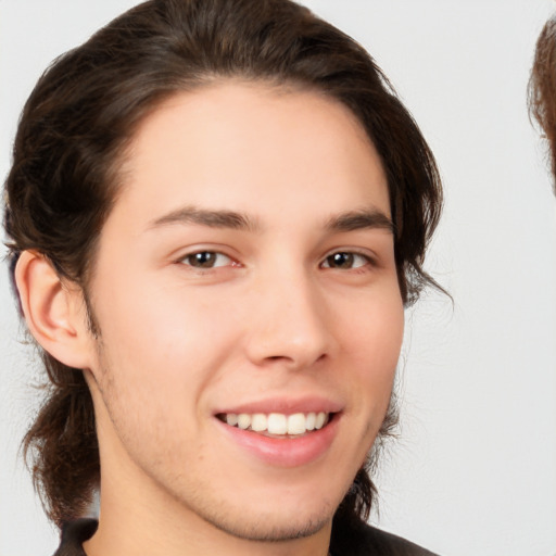 Joyful white young-adult male with medium  brown hair and brown eyes