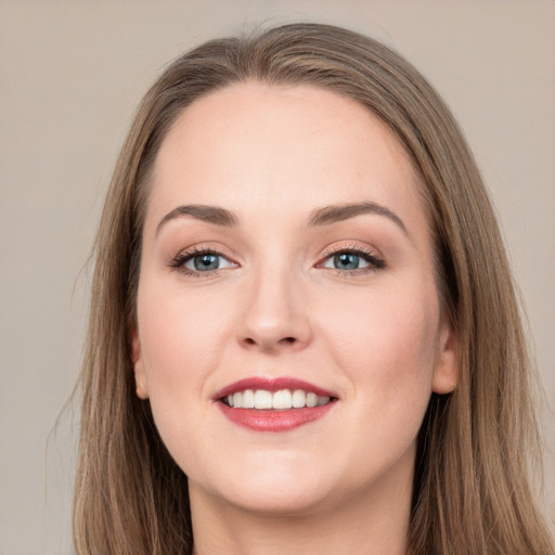 Joyful white young-adult female with long  brown hair and grey eyes