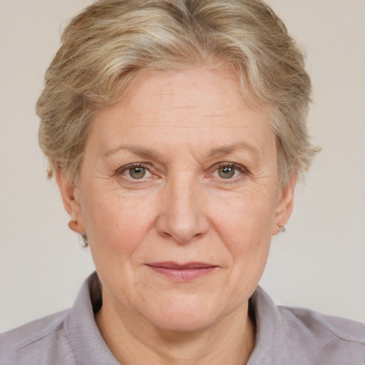 Joyful white middle-aged female with short  brown hair and blue eyes