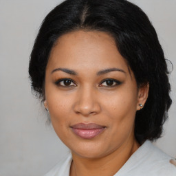 Joyful latino young-adult female with medium  black hair and brown eyes