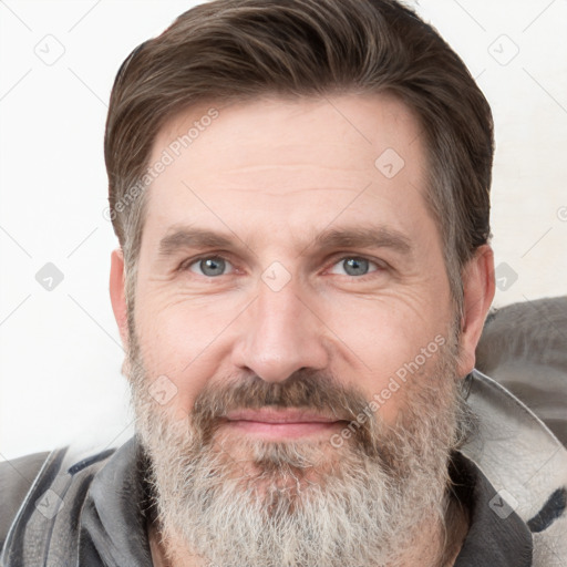 Joyful white adult male with short  brown hair and grey eyes