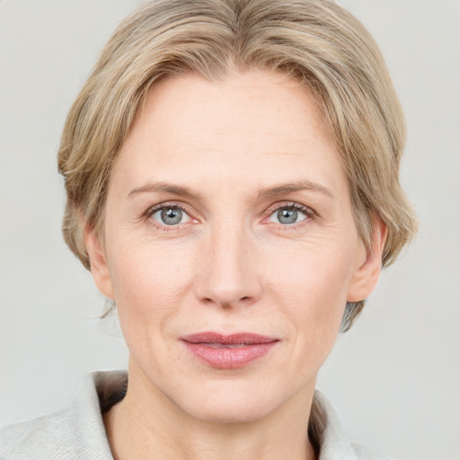 Joyful white adult female with medium  brown hair and blue eyes