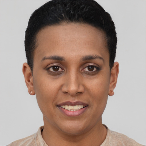 Joyful latino young-adult female with short  black hair and brown eyes