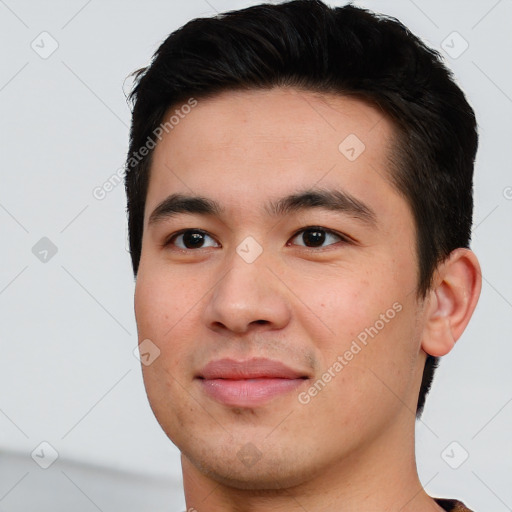 Joyful white young-adult male with short  black hair and brown eyes